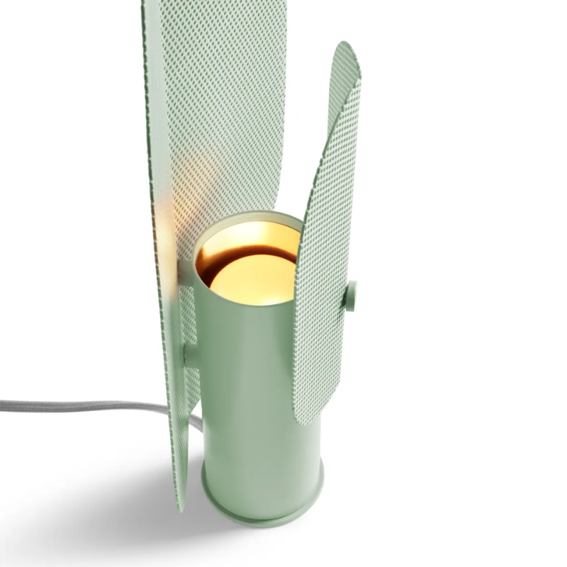 The Filter Table Lamp from Blu Dot in mint focusing on the bulb turned on.