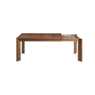 The 60 to 84 inch Moreover Extension Dining Table from Blu Dot in walnut collapsing.