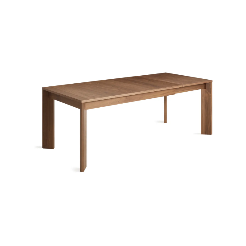 The 60 to 84 inch Moreover Extension Dining Table from Blu Dot in walnut extended from a top angle.