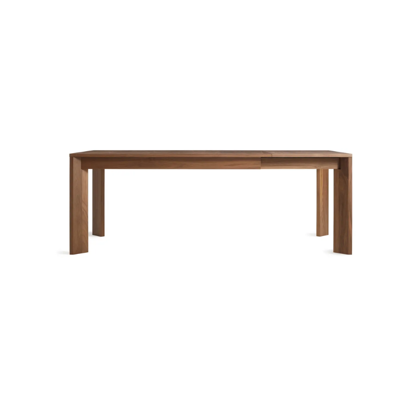 The 60 to 84 inch Moreover Extension Dining Table from Blu Dot in walnut extended.