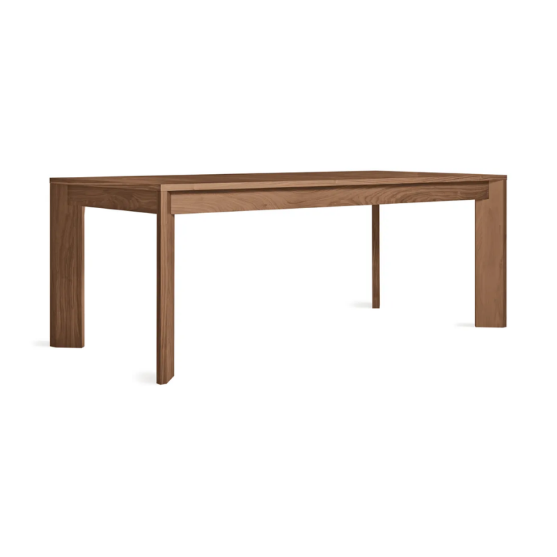 The 80 to 104 inch Moreover Extension Dining Table from Blu Dot in walnut from an angle.