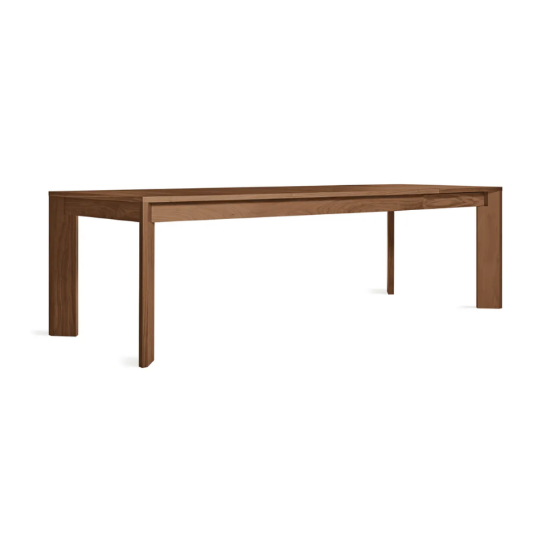 The 80 to 104 inch Moreover Extension Dining Table from Blu Dot in walnut extended from an angle.