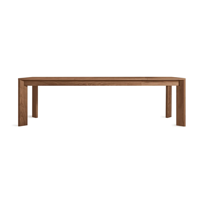 The 80 to 104 inch Moreover Extension Dining Table from Blu Dot in walnut extended.