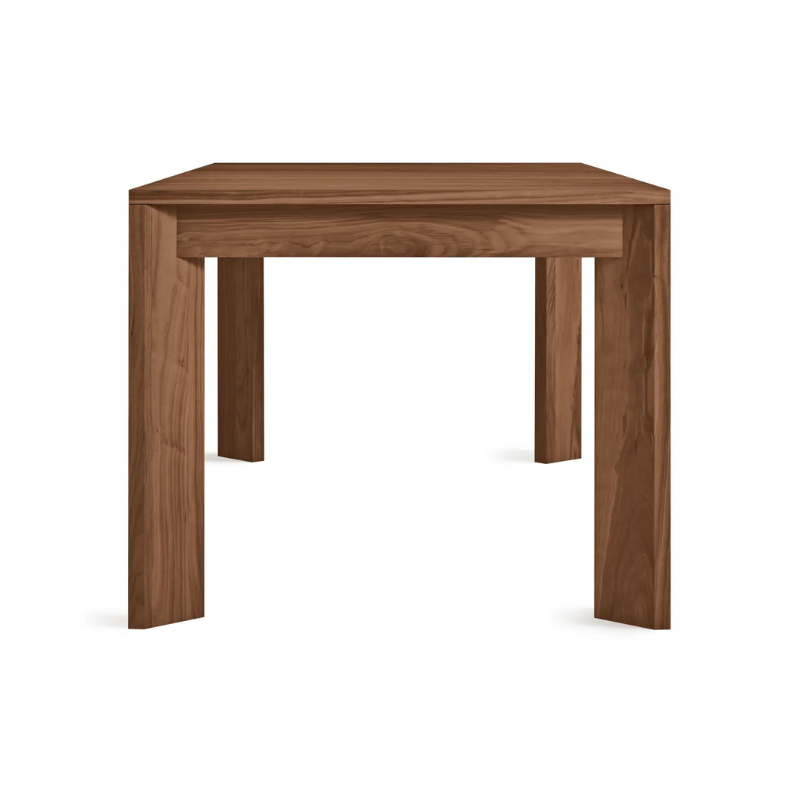 The 80 to 104 inch Moreover Extension Dining Table from Blu Dot in walnut from the side.