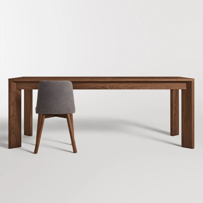 The 80 to 104 inch Moreover Extension Dining Table from Blu Dot in walnut in a studio.