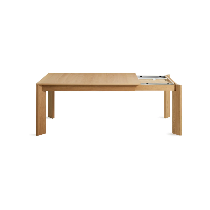 The 60 to 84 inch Moreover Extension Dining Table from Blu Dot in white oak collapsing.