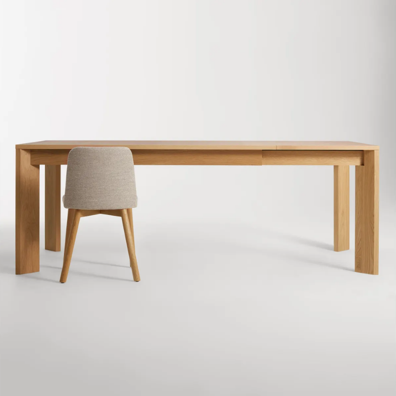 The 60 to 84 inch Moreover Extension Dining Table from Blu Dot in white oak extended in a lifestyle.