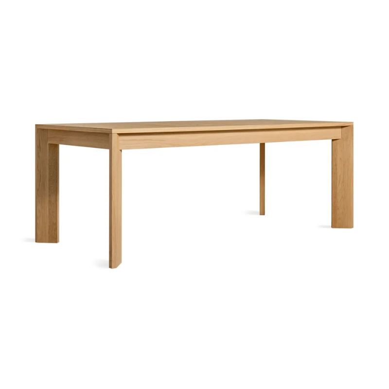 The 80 to 104 inch Moreover Extension Dining Table from Blu Dot in white oak from an angle.