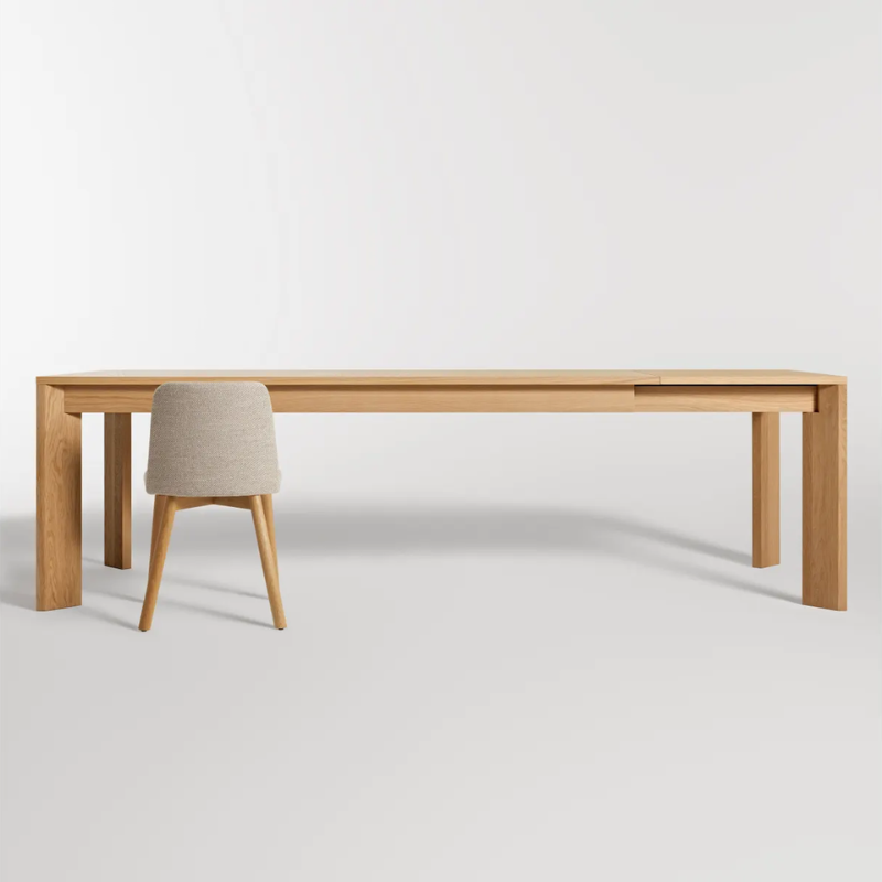 The 80 to 104 inch Moreover Extension Dining Table from Blu Dot in white oak extended in a studio.