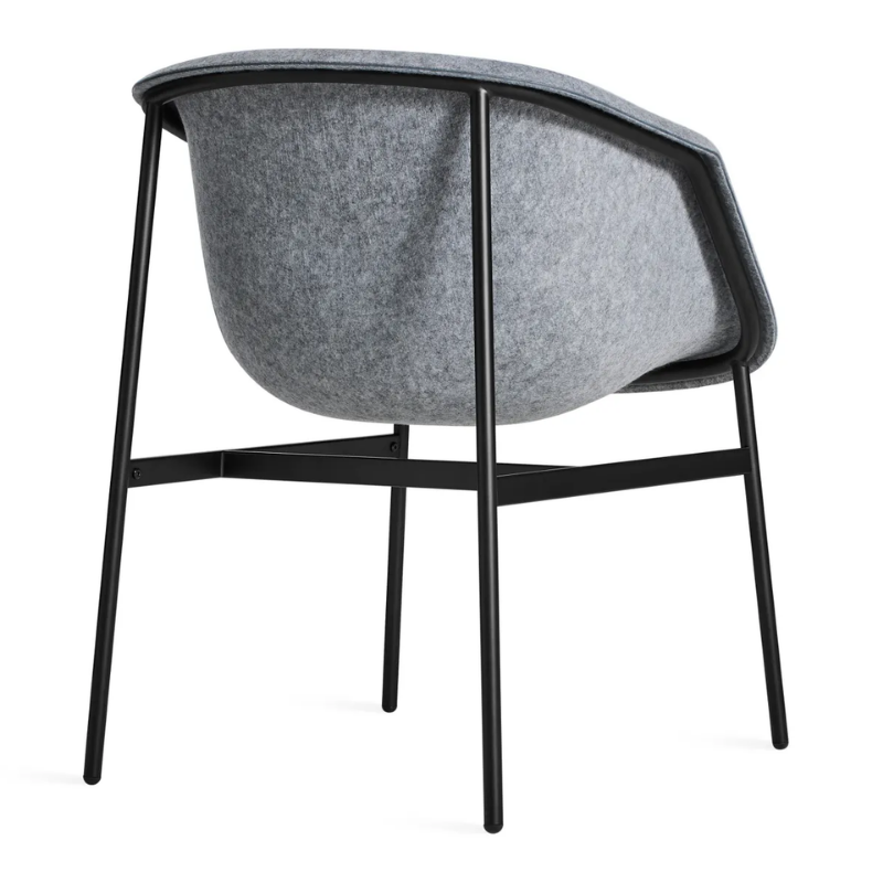 The Past Life Chair from Blu Dot with light grey seat and black base from the back at an angle.