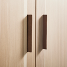 The Shale Wardrobe from Blu Dot in hickory highlighting the leather handles.