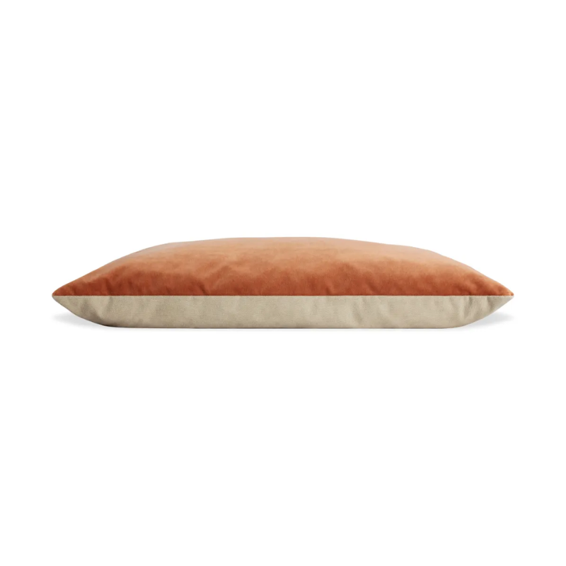 The small Signal Dog Bed from Blu Dot with copper velvet upholstery from the side.