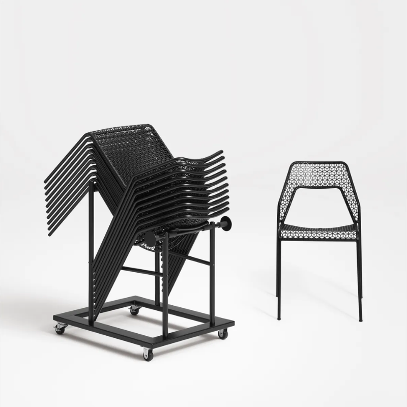 The Stacking Chair Dolly from Blu Dot holding a stack of Hot Mesh Chairs.