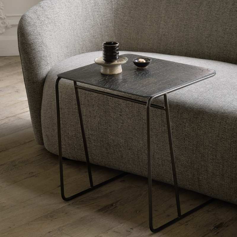 The Ellipse Side Table from Ethnicraft in a living room.