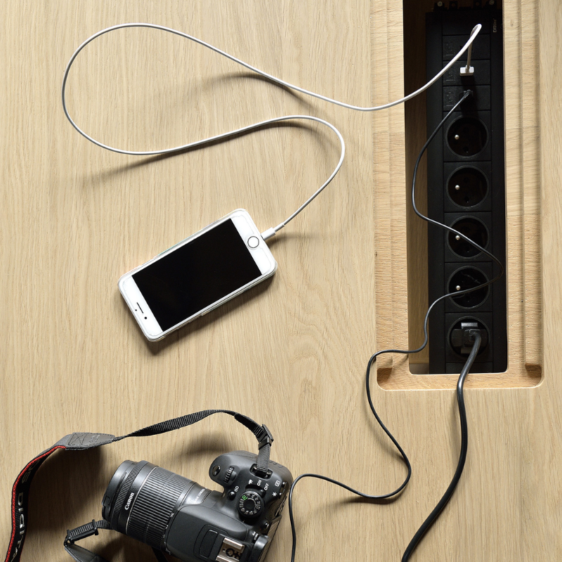 The Mikado Meeting Table from Ethnicraft power outlet charging electronics (not included).