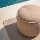 The Nomad Indoor and Outdoor Rug from Ethnicraft poolside.