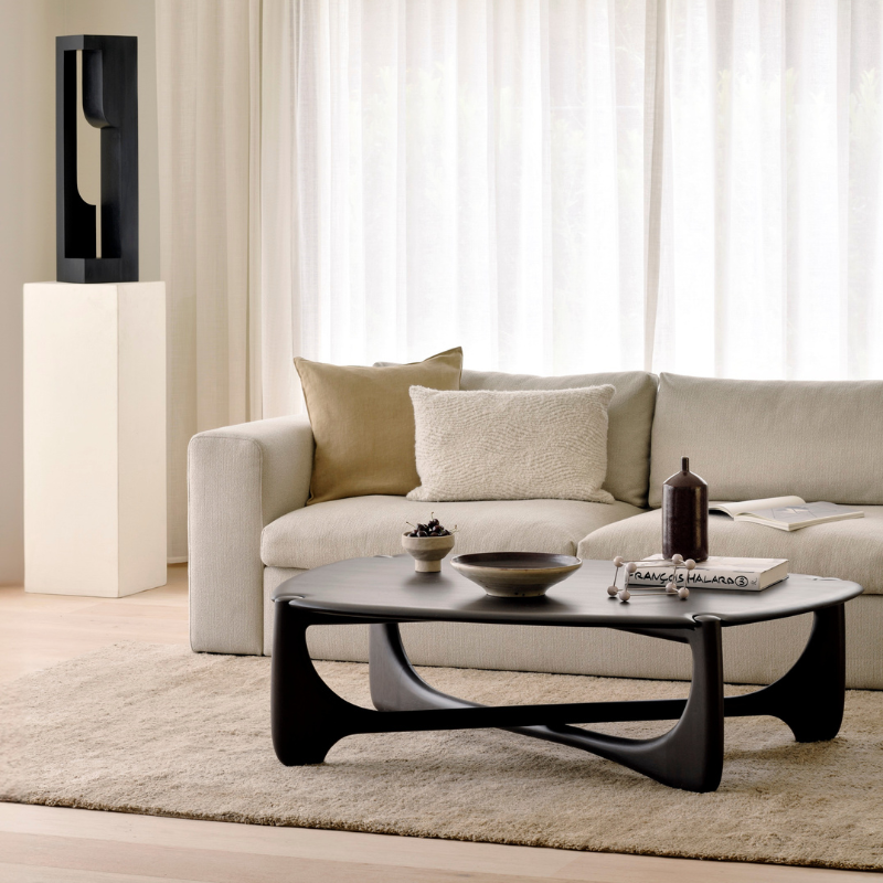 The Pebble PI Coffee Table from Ethnicraft in a living room with the Mellow Sofa and Dunes Rug