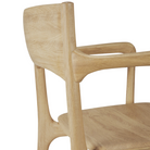 The PI Dining Chair from Ethnicraft with an armrest in a close up.