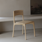 The PI Dining Chair from Ethnicraft without an armrest in a lounge.