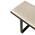 The Stability bench from Ethnicraft showcasing its black metal frame and upholstered seat