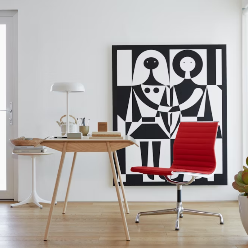 The Eames Aluminum Group Side Chair from Herman Miller in a living room.