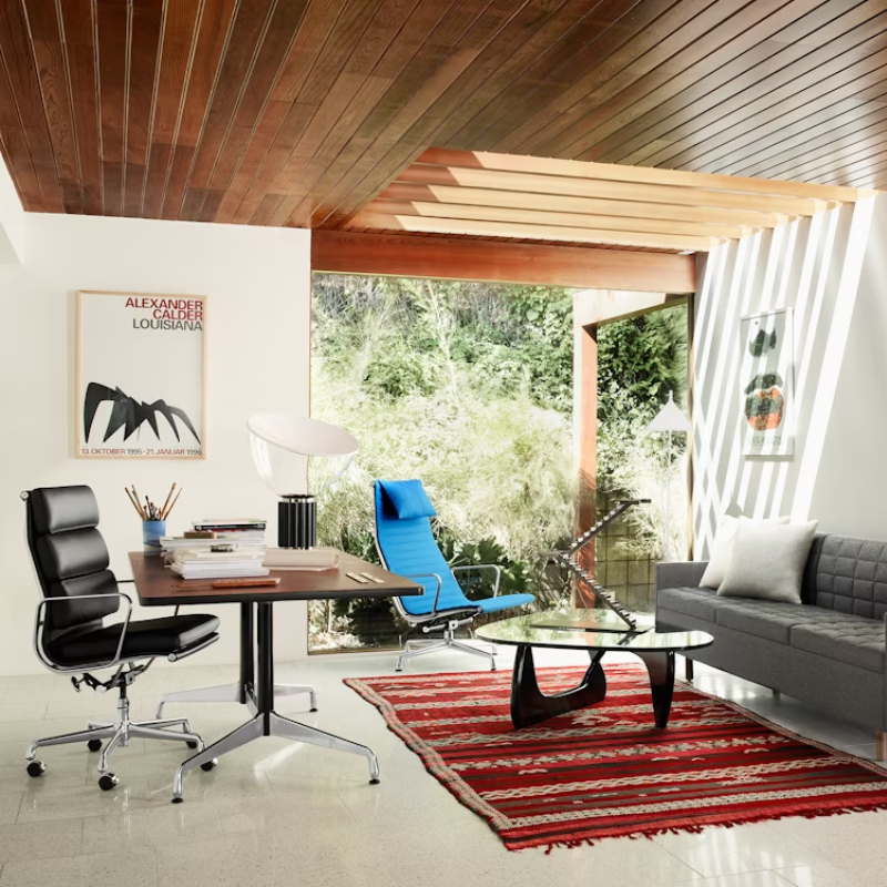 The Eames Soft Pad Executive Chair from Herman Miller in a living room.