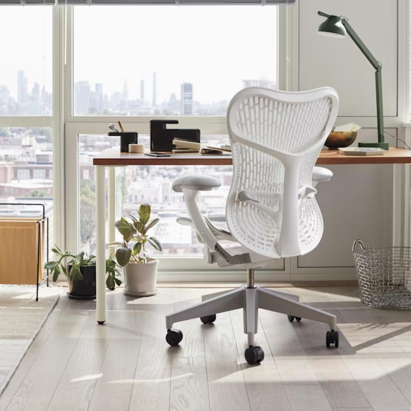 The Mirra 2 Chair from Herman Miller in alpine at a desk.