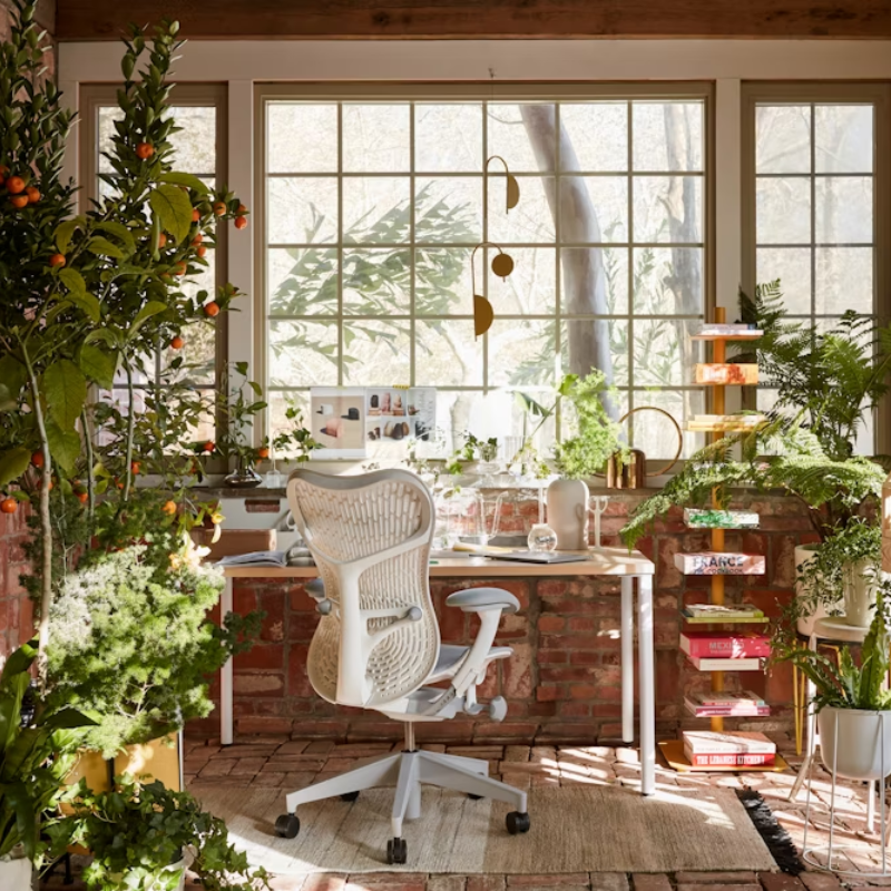 The Mirra 2 Chair from Herman Miller in alpine in a workspace.