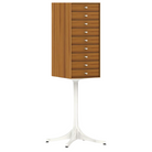 The Nelson Miniature Chest 9 Drawer from Herman Miller in teak with a studio white base and studio white pulls.