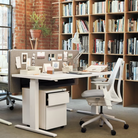 The Sayl Chair from Herman Miller in mineral with a white frame in a business.