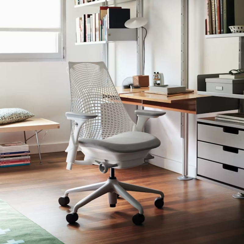 The Sayl Chair from Herman Miller in mineral with a white frame at a desk.