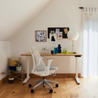 The Sayl Chair from Herman Miller in mineral with the white frame in a workspace.