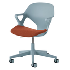 The Zeph Multipurpose Chair with Arms from Herman Miller glacier shell with cayenne seat pad.