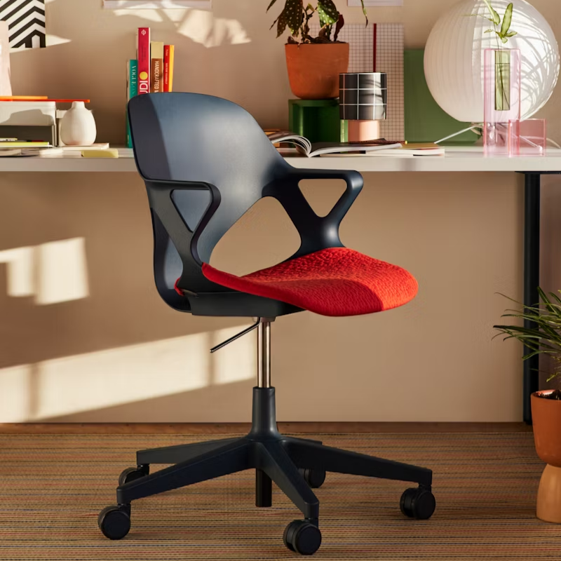 The Zeph Multipurpose Chair with Arms from Herman Miller in a living room.