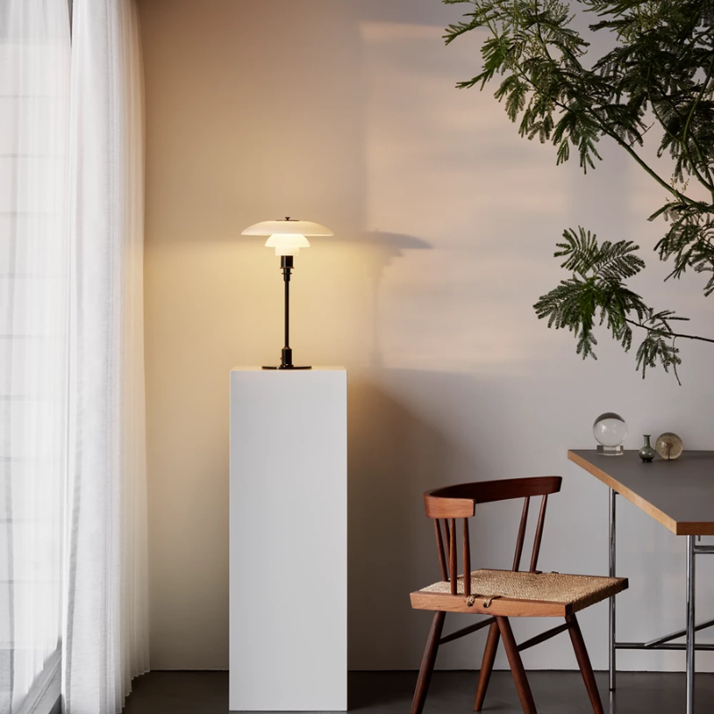 The PH 3/2 Glass Table Lamp from Louis Poulsen in a dining room.