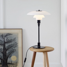 The PH 3/2 Glass Table Lamp from Louis Poulsen in a gallery.