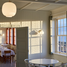 The VL Ring Crown Wall Light from Louis Poulsen in a dining room.