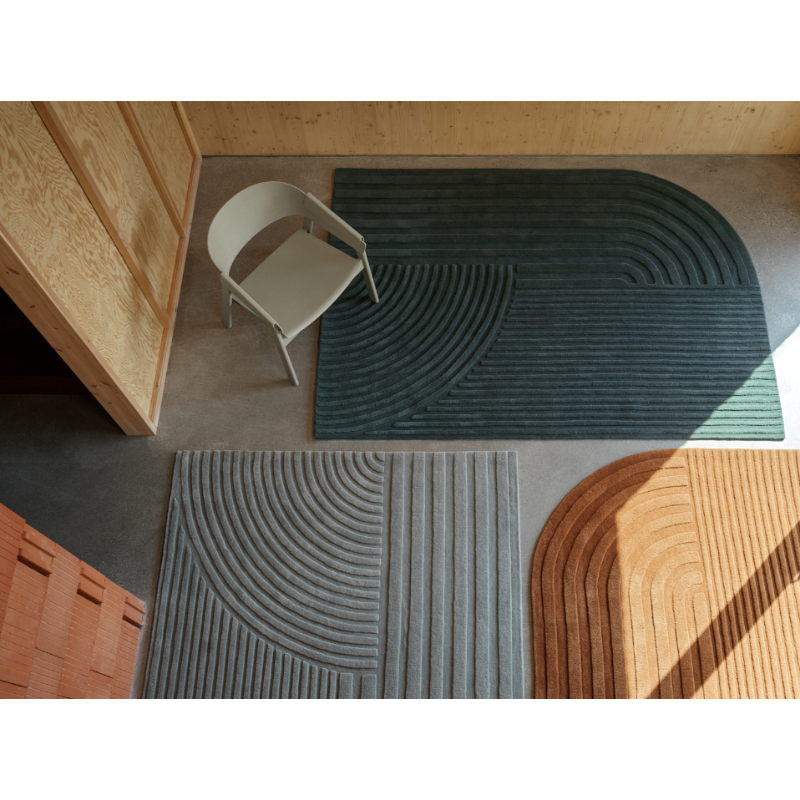 The Relevo Rug from Muuto, an asymmetrical area rug in a studio space.