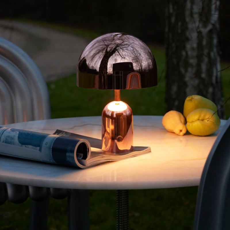 The Bell Portable LED from Tom Dixon in a garden.