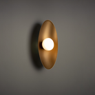 The Glamour Wall Sconce from WAC Lighting in a lounge.