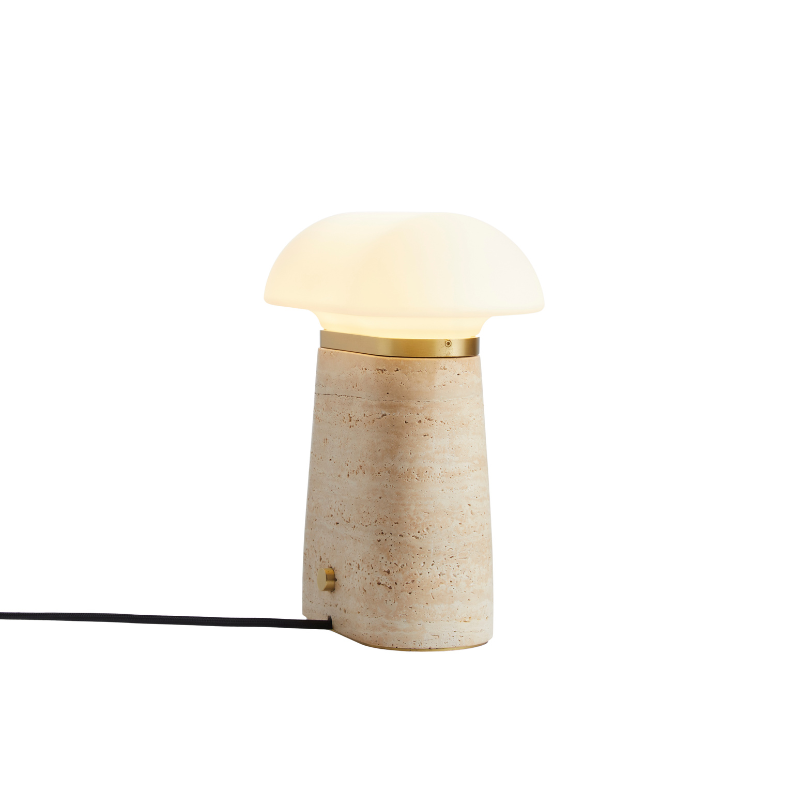 The Nova Table Lamp by Woud in ivory travertine from a side view.