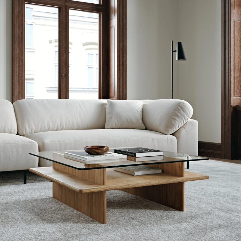 The square Parallel Coffee Table from Woud made with oak and a glass top in a living room with the collar sofa.