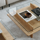 The square Parallel Coffee Table from Woud made with oak and a glass top in a living space.