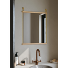 The small Suspended Mirror by Woud above a bathroom sink.