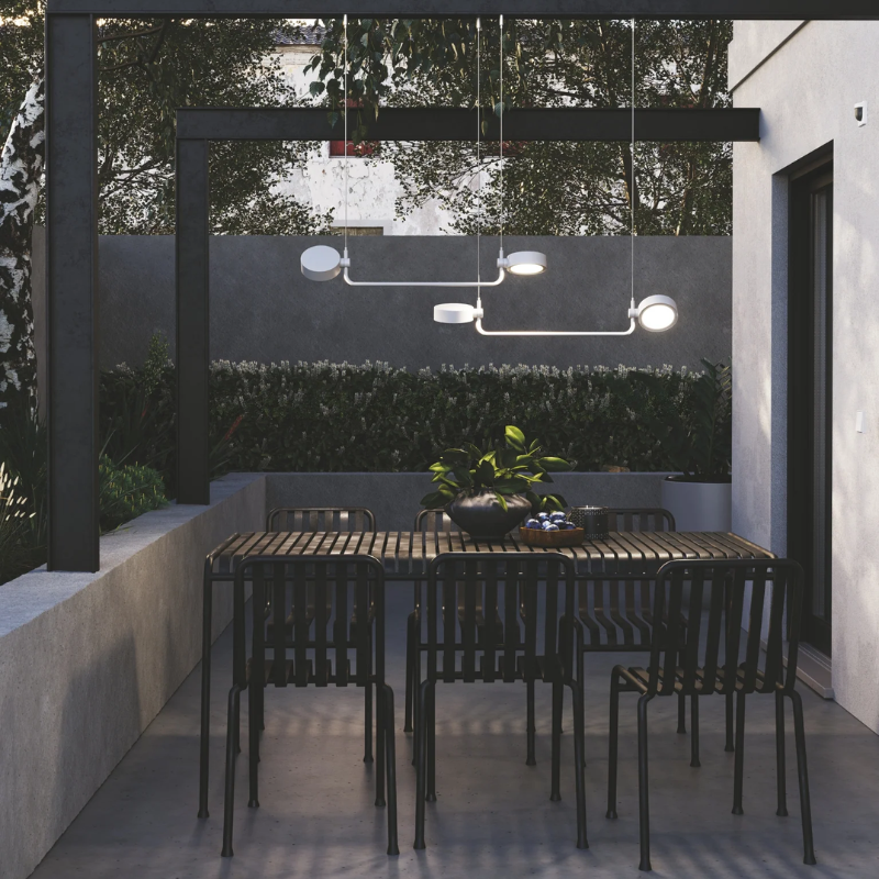 The Super O Hanging Lamp from Zafferano outdoors in a dining area.