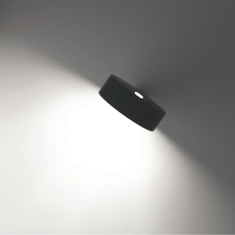 The short Super O Wall Lamp from Zafferano in a living room.